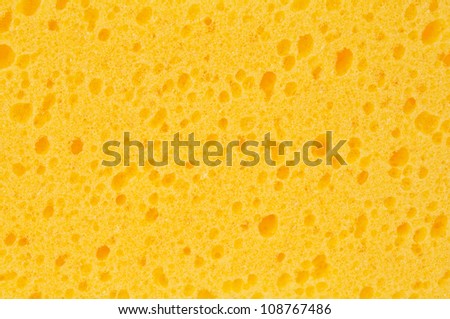 Close-up of yellow cleaning sponge. Background or texture