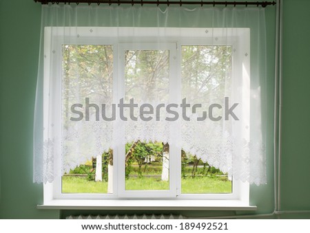 room with  window and curtain