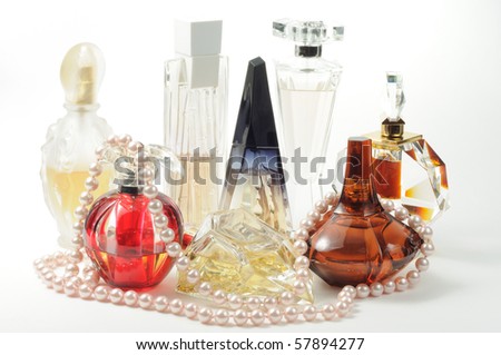 Woman perfumes with pear necklace on white
