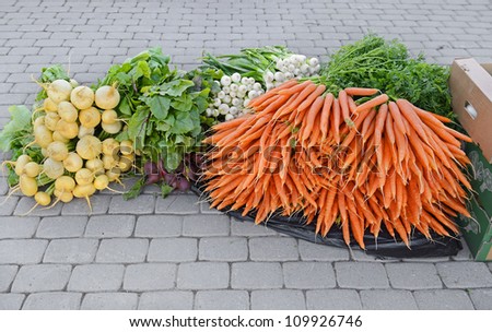 Fresh vegetables on the pavement.  Before the opening of the market, preparation for sale
