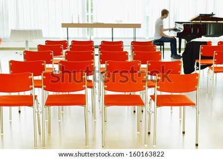 In the concert hall (focus on the chairs)
