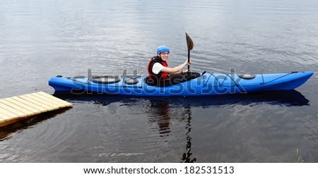 Sports and recreation. Young man kayaking