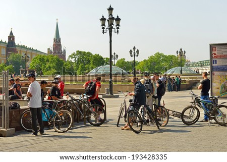 MOSCOW, RUSSIA - MAY 18, 2014:Cycling is convenient, fast, healthy, ecological and memorable way to see and explore all Moscow tourist attractions. Cyclists on Manege Square near Kremlin