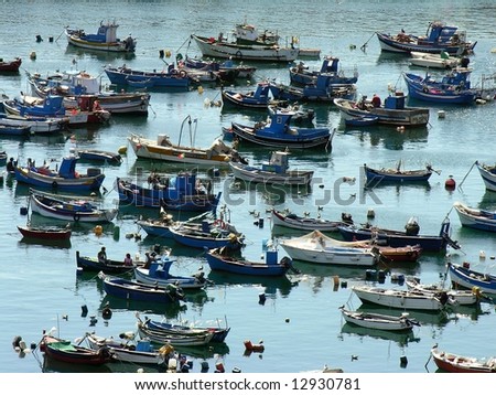 Moored traditional fishing boats in a typical harbor, in the south west coast of Portugal, sines