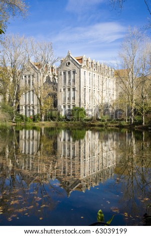 The old military headquarters and high school college building reflected over the lake at Parque D. Carlos I, in Caldas da Rainha, Silver Coast, Portugal