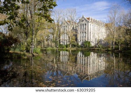 The old military headquarters and high school college building reflected over the lake at Parque D. Carlos I, in Caldas da Rainha, Silver Coast, Portugal