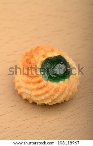 Traditional italian biscuit with almond and a green candied fruit on top