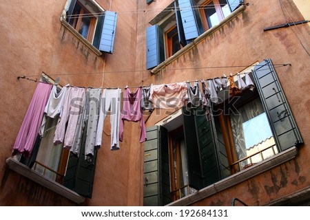 Laundry hanging on the window of an old mediterranean house