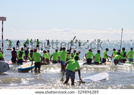 LIGNANO, ITALY - september 6, 2015: SUP race. Stand up paddle surfing and boarding were born in Hawaii. The athletes maintain an upright stance on their boards using a paddle to race over the sea.