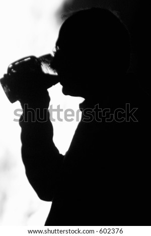 silhouette of a man drinking beer
