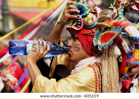 peruvian mask-dancer drinking