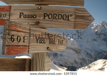 wooden mountain direction signs in the dolomites of the italian alps show skiers where to go