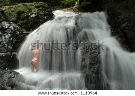 Sexy female model posses in and around waterfalls of Costa Rica