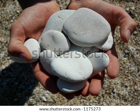 Pile of skipping stones held in hands