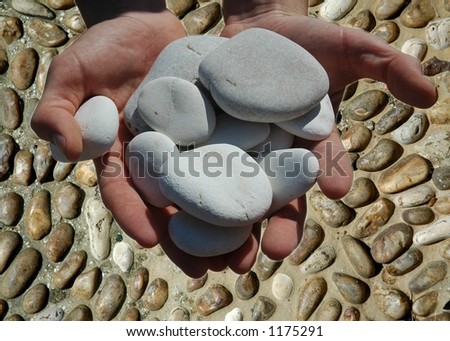 Pile of skipping stones held in hands