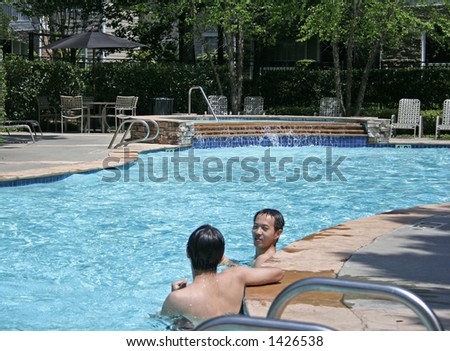 two people having conversation in the pool