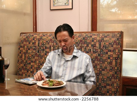 business man showing ugly face that he doesn\'t like his lunch