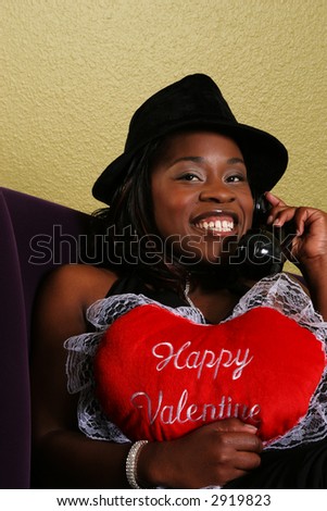 african american woman close up portrait talking on the phone with her boyfriend and holding \