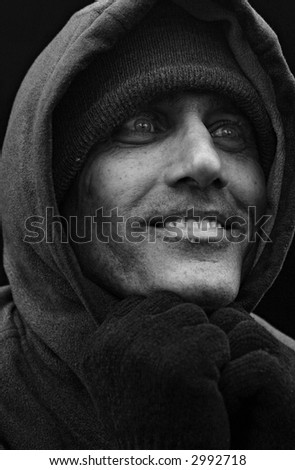 close up black and white portrait of urban man looking to the side with big smile