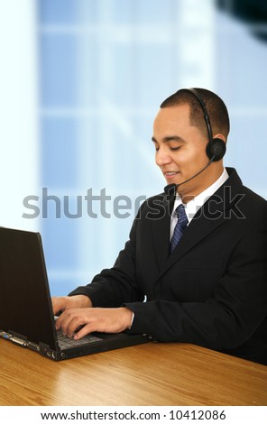 customer representative assisting customer on the phone in his office