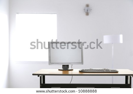 modern setting of contemporary empty office space with computer screen and keyboard