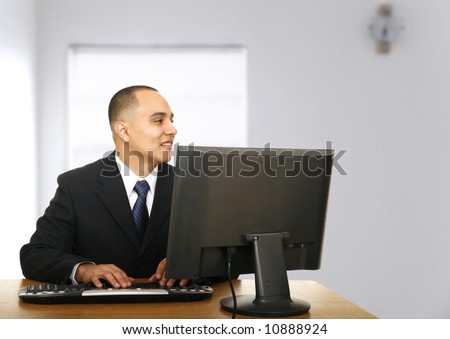 an office worker look to his side when called by his coworker which not shown on the picture