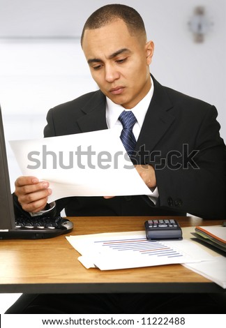 a business man looking at paper work in his office