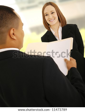business man looking at empty folder as if he is reviewing his woman teammate work. the concept is business deal or work related