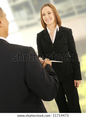 business man giving a folder to his teammate in modern office environment. concept for business deal or business team