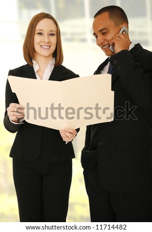 two business people with concept of reviewing work, the business man is on the phone and looking at the folder