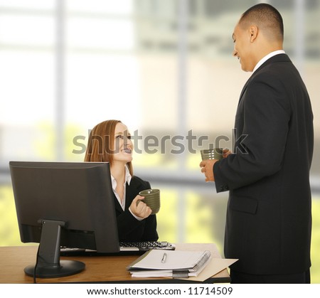 two business people talking and holding coffee cup, both showing happy expression. concept for office break, relax, lunch break, or business chat