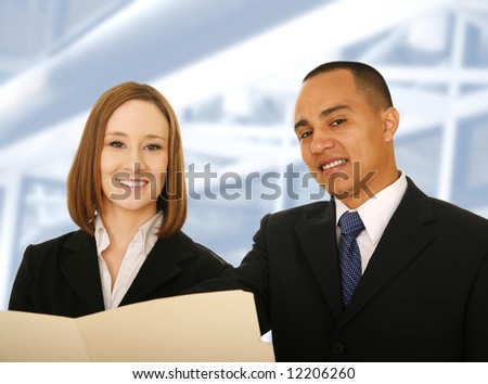 two business people holding folder and looking at the camera and smile. concept for business team