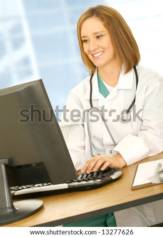 busy doctor smiling and typing on computer. concept for medical field and modern office