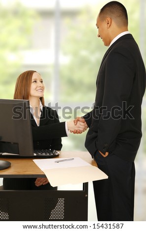 business man standing and shake hand with business woman. concept for office related, business deal, or team work