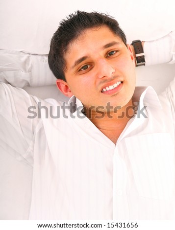 smiling young man relax, laying down on the floor