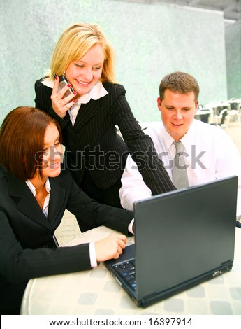 blond business woman presenting project on her laptop and talking on the phone at the same time