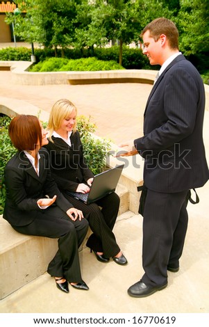 three business people having an informal meeting outdoor