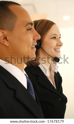 two business people, one of them wearing headset in office environment. concept for customer care or service