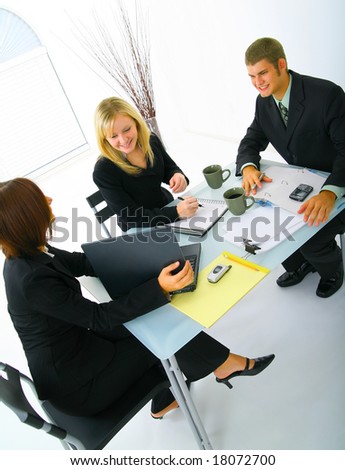 happy caucasian business people working together as a team. business woman presenting a laptop to her two other coworkers