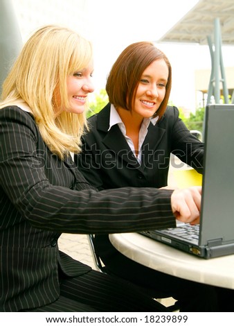 two happy business woman looking at laptop with smile. concept for business
