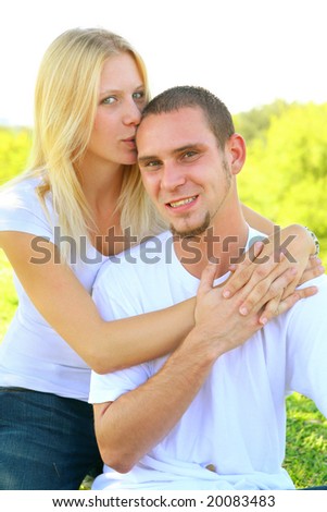 beautiful shot of female caucasian kiss her boyfriend sharing their love