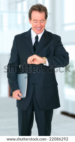 senior businessman caucasian checking on his watch as he walk out of his office