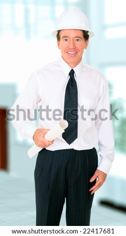 senior male contractor holding blue print and standing by his office
