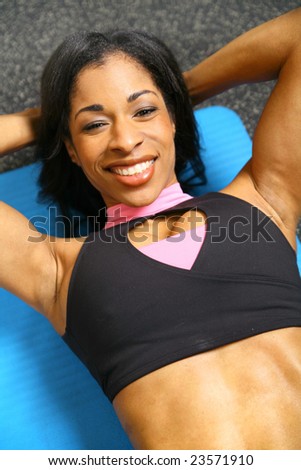 close up african american woman training or exercising in gym, doing sit up