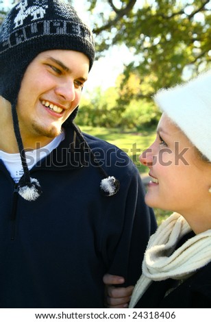 two nice romantic young caucasian couple in urban style walking in the park