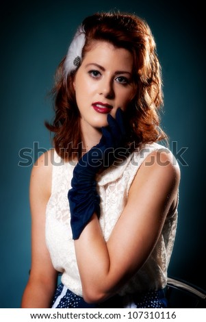 Beautiful young retro style female in long blue gloves