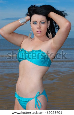 Cute young woman in bikini at beach