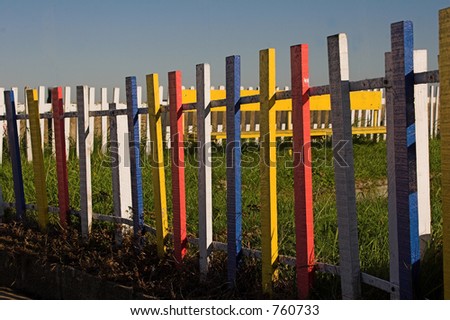 Railed fence painted red,blue,yellow & white