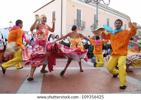 ASSEMINI, SARDINIA - AUGUST 1: A folklore dancing group from Columbia, performs during the International Folk Festival  Is Pariglias 2012, on August 1, 2012 in Assemini, Sardinia.