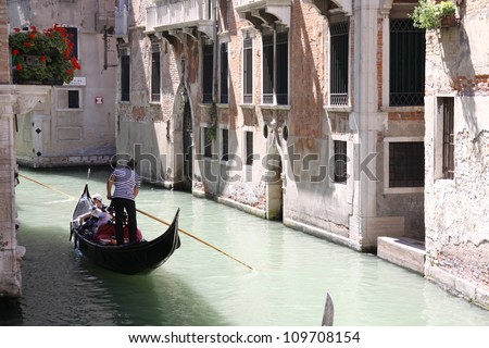 VENICE, ITALY - AUGUST 2: Tourists on a Gondola, August 2, 2012 in Venice, Italy. The city has an average of 50,000 tourists a day and it\'s one of the world\'s most internationally visited city